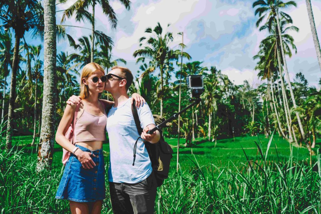 Happy couple taking selfie kissing