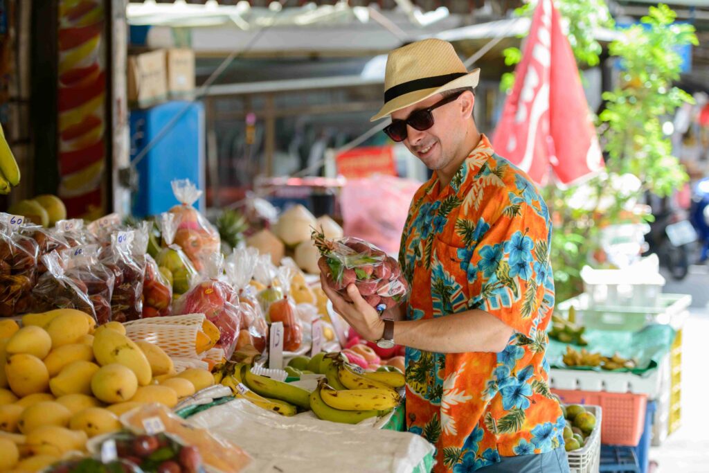 Portrait of young handsome tourist man at the streÿØÿà