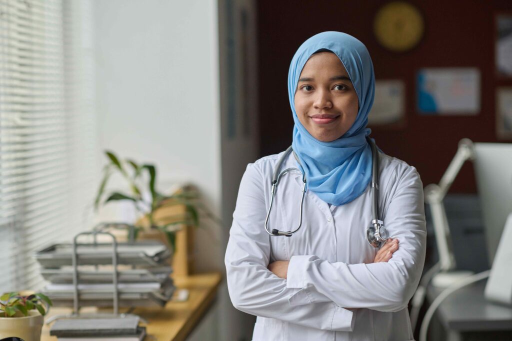 Portrait of Young Cheerful Medical Worker in Traditional Muslim Attire