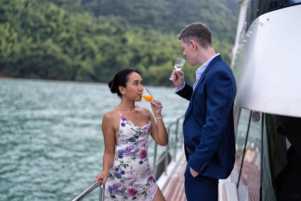 Romantic couple in love have fun sailing in the sea standing on yacht deck enjoy amazing view