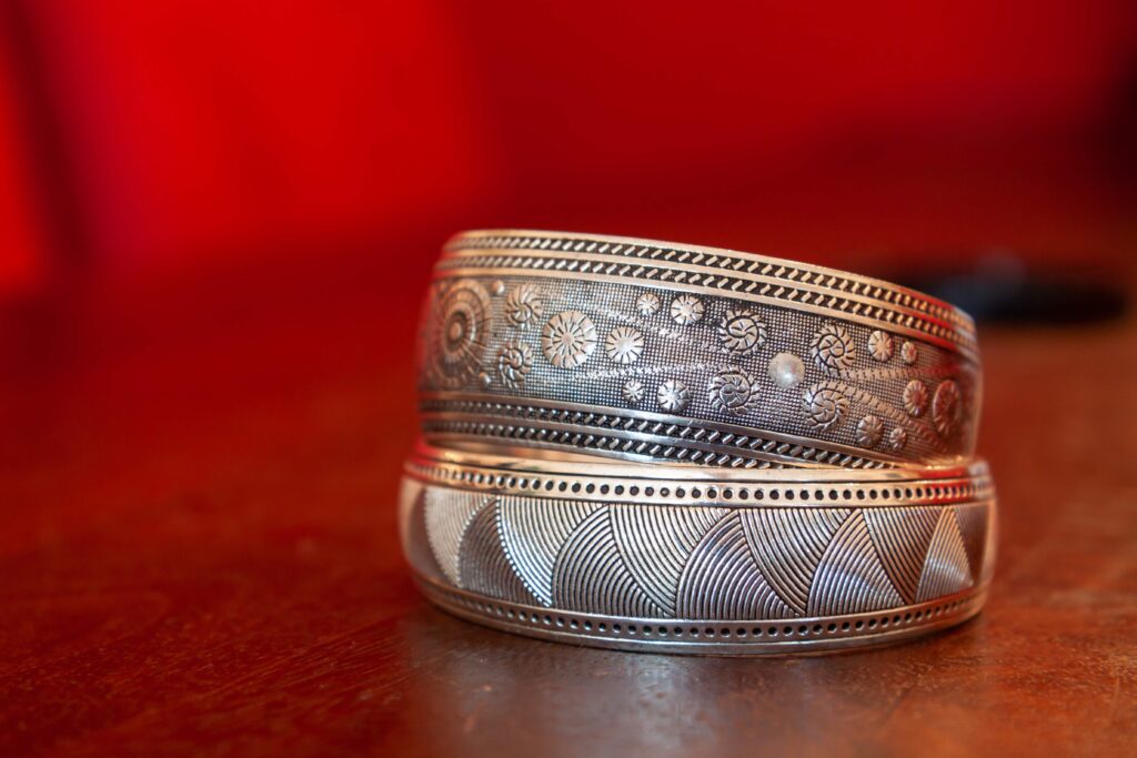 Selective focus shot of silver jewelry on red background