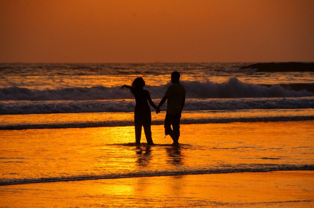 Silhouette of tourist at beach on Sunset, Goa, India