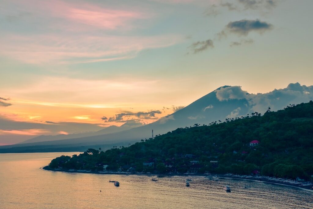 Top view of Amed beach and volcano Agung at sunset Bali, Indonesia