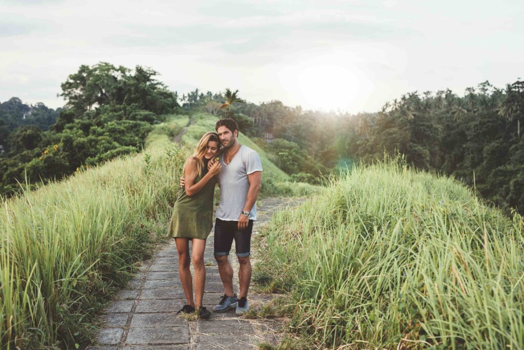 Young couple walking through country road