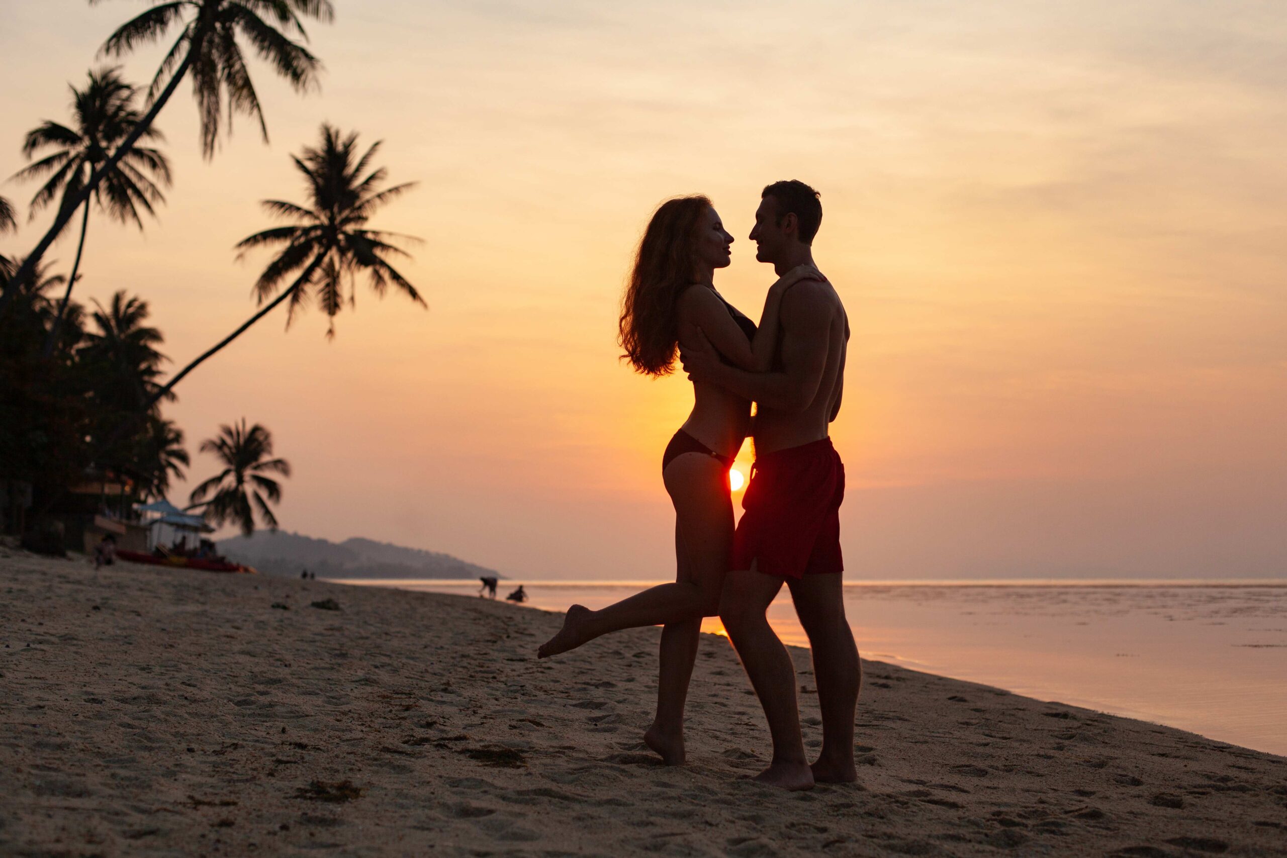 young sexy romantic couple in love happy on summer beach together having fun wearing swim suits