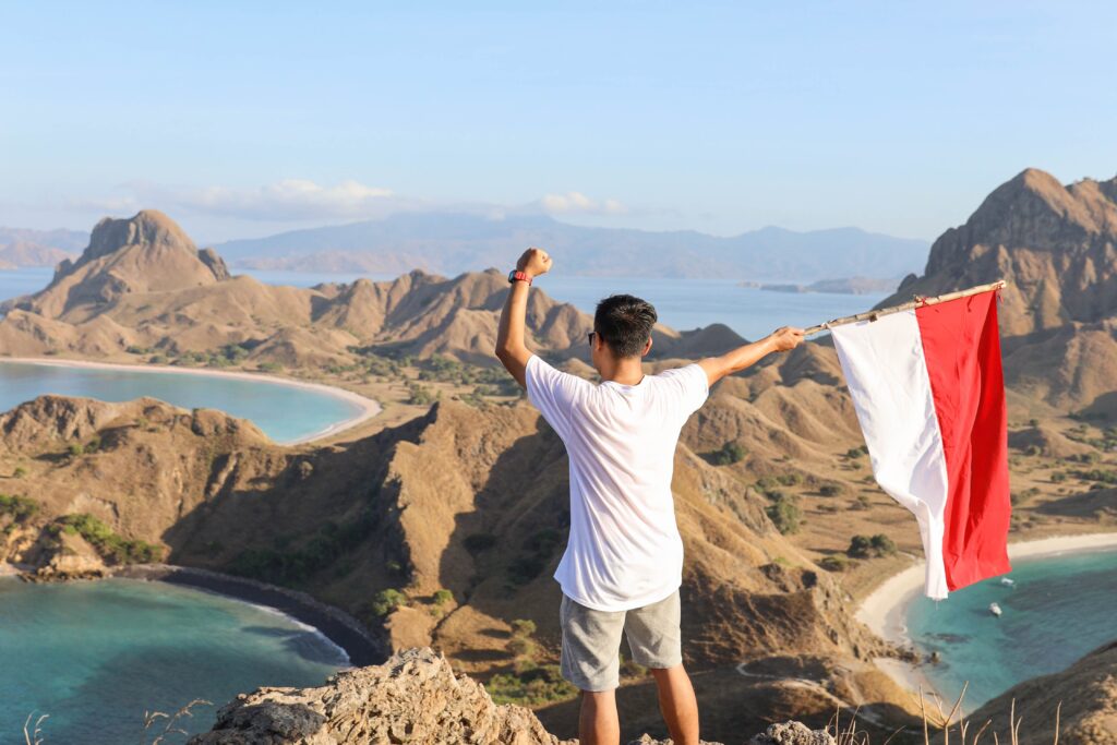 a man holding and waving indonesian flag on top mo 2023 11 27 05 10 21 utc
