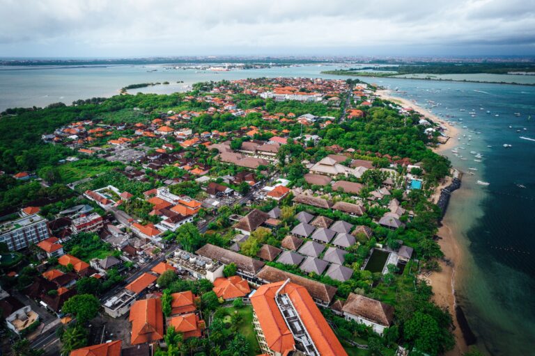 Aerial view of a luxurious coastal resort located on a sunny beach of a tropical island in Indonesia