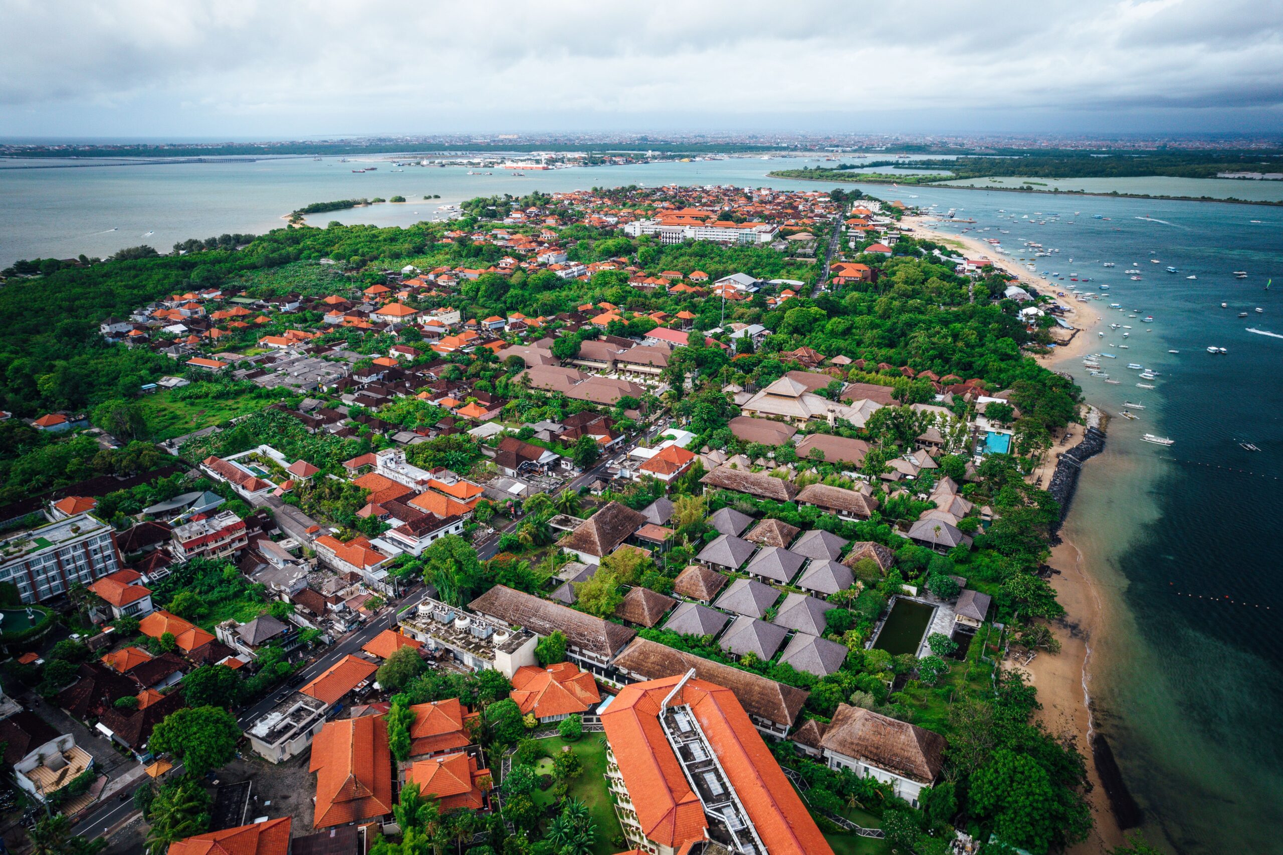 Aerial view of a luxurious coastal resort located on a sunny beach of a tropical island in Indonesia