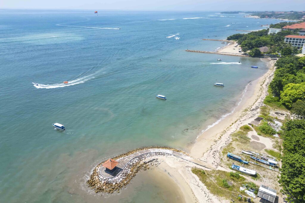 Aerial view of the seashore with hotels and boats in the sea