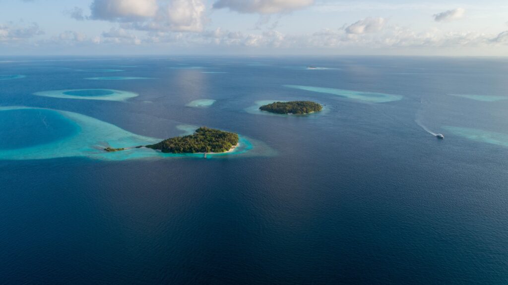 Aerial view of tropical islands surrounded by turquoise waters and coral reefs in the Maldives