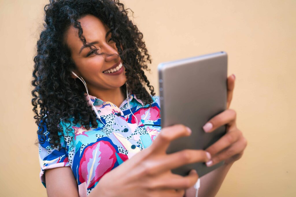 Afro woman taking selfies with her digital tablet