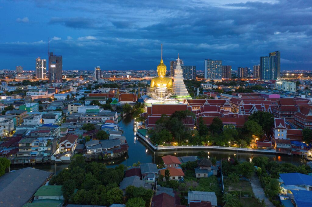 Aerial view of the Giant Golden Buddha in Wat Paknam Phasi Charoen Temple in Phasi Charoen district on Chao Phraya River at night, Bangkok Urban town, Thailand Downtown City