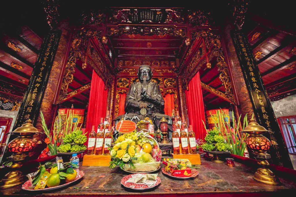 Beautiful shot of a Buddhist temple altar with a Confucius statue and decorations in Vietnam