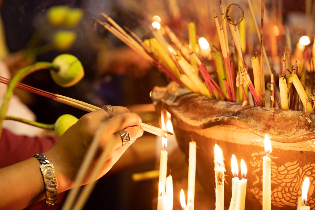 Burning incense sticks in a Buddhist Temple in Thailand