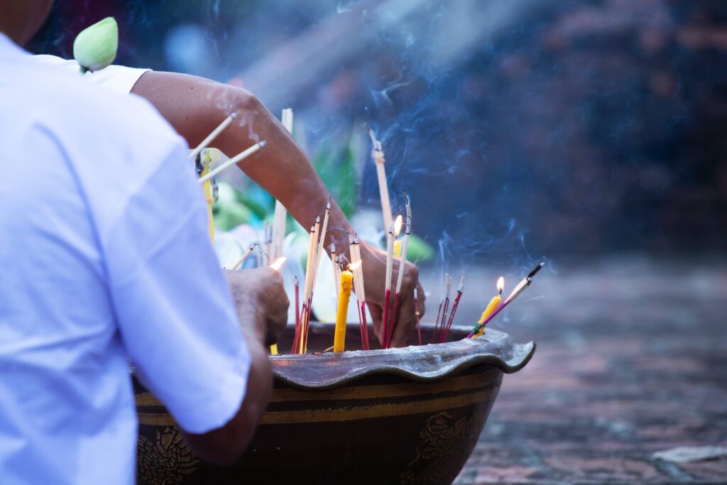 Burning incense sticks in a Buddhist Temple in Thailand