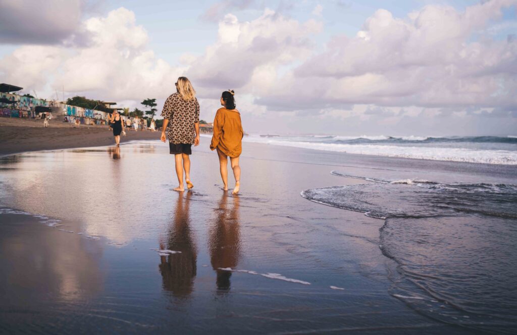 Couple walking along sandy beach