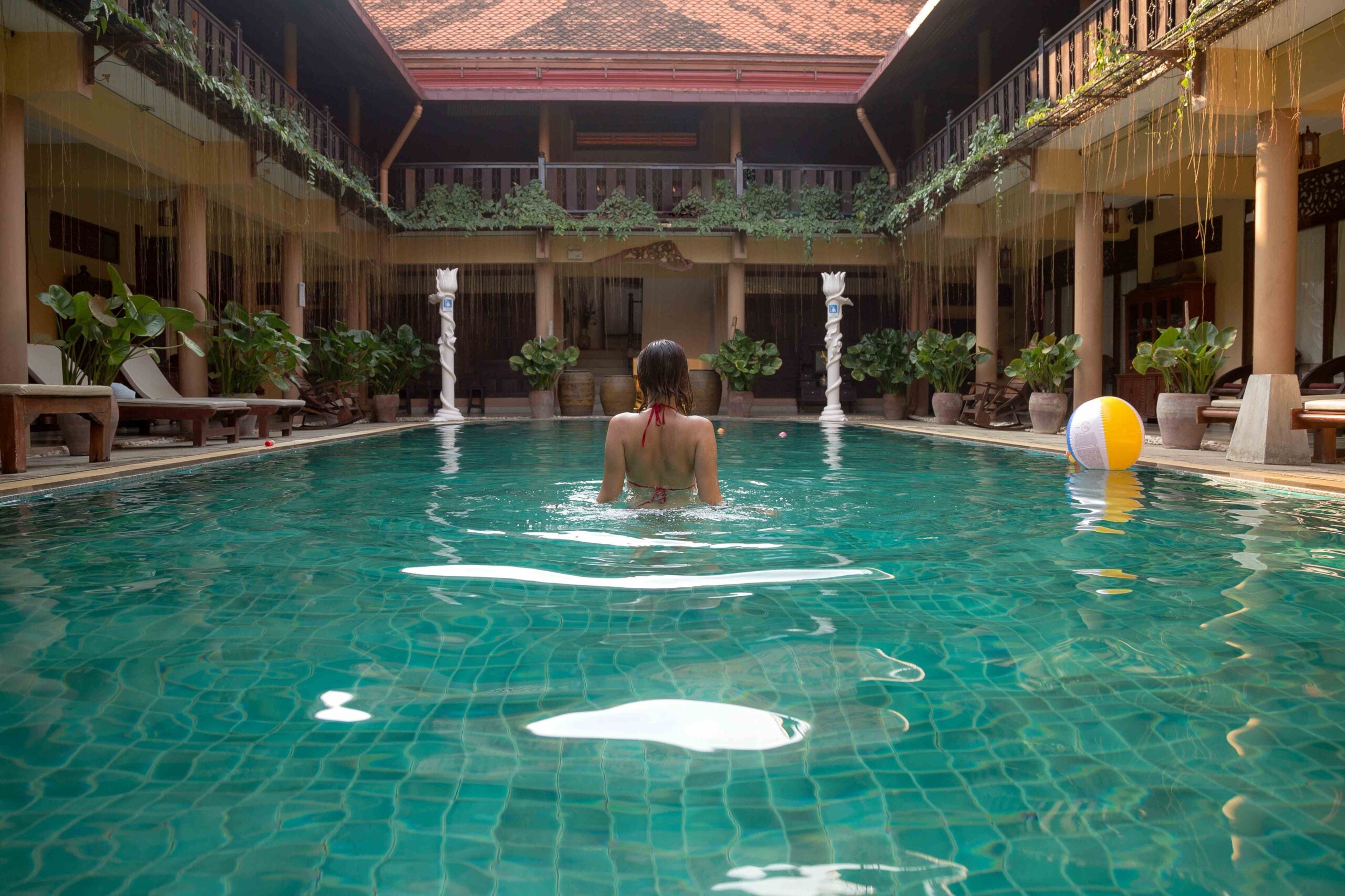Girl at travel spa resort pool Summer luxury vacation