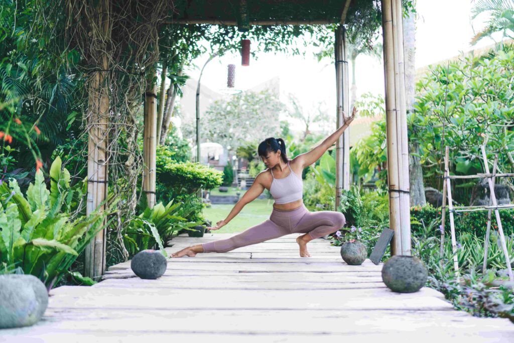 Girl practicing yoga on wooden terrace outdoor