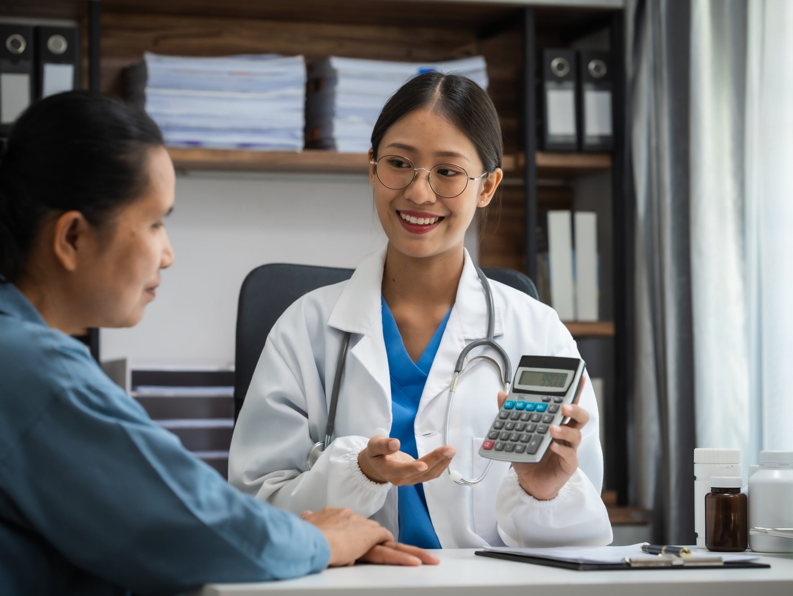 Mature chinese woman in consultation with a doctor with abdomina