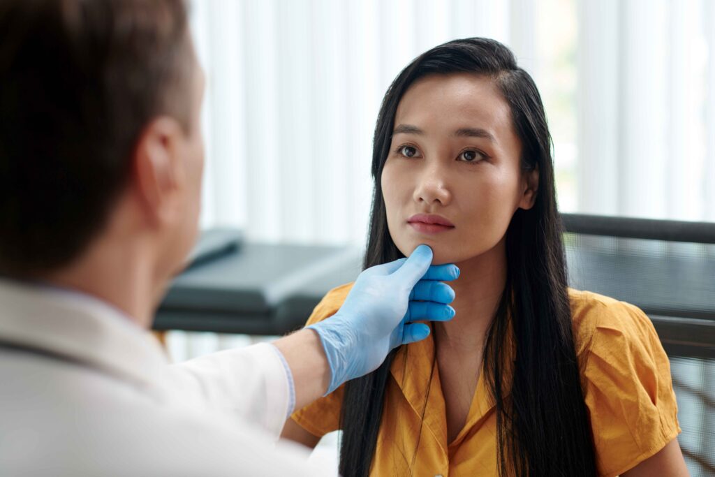 Plastic Surgeon Examining Face of Woman