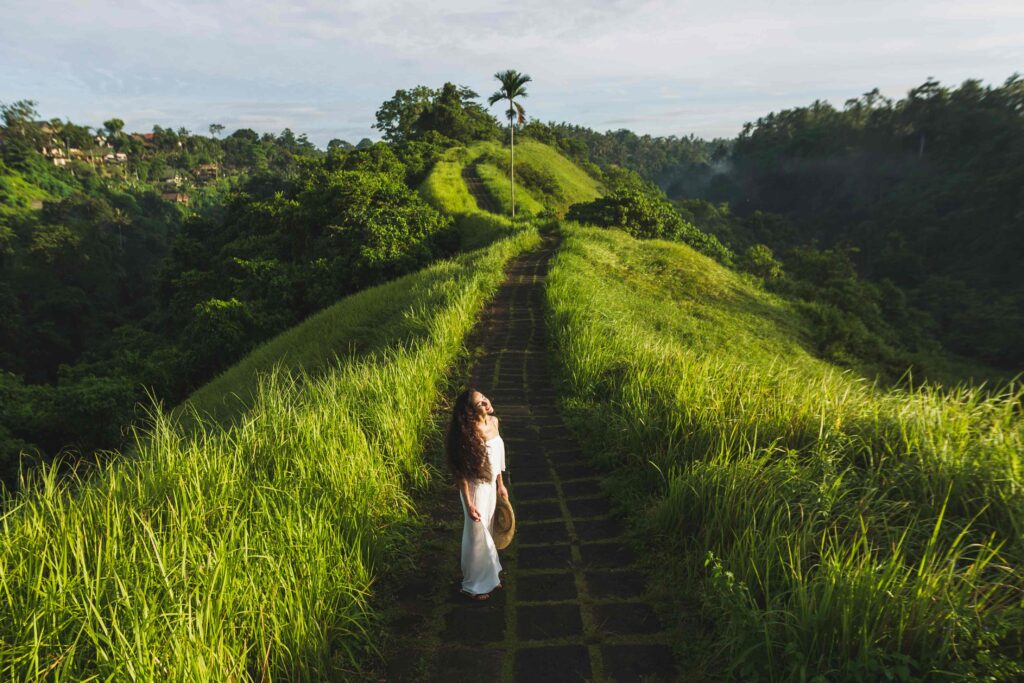 Young beautiful woman walking on Campuhan Ridge way of artists,