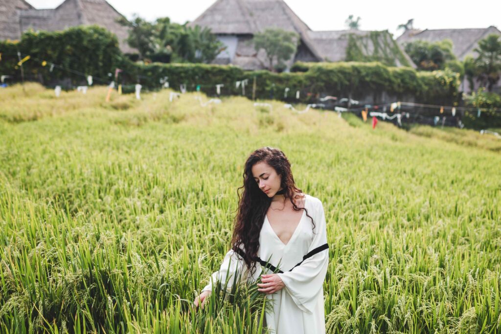 Young woman in white tunic in rice fields Bali in Tegallalang R