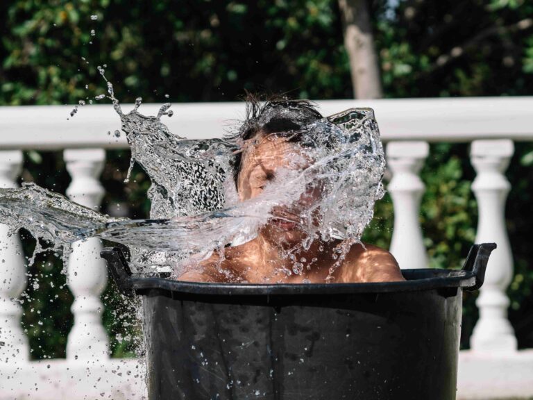 High speed photograph that captures the impact of water by hitting the face of a teenage boy