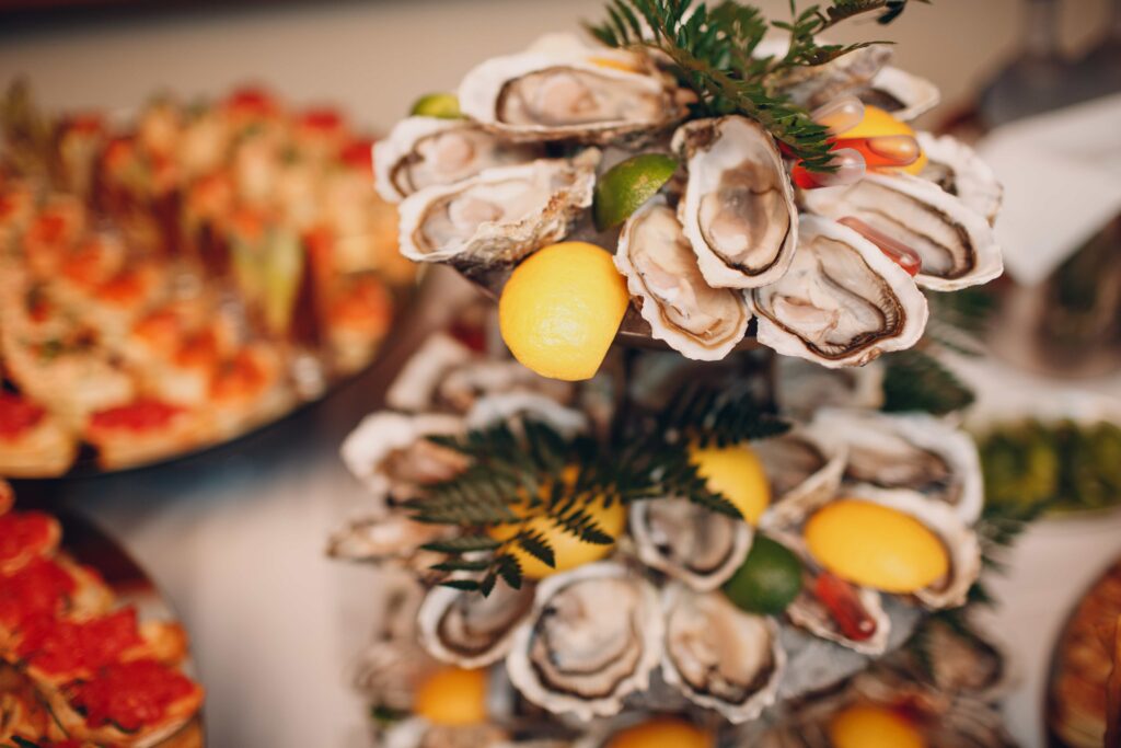 oysters with lemon on a platter in a restaurant on a white table catering