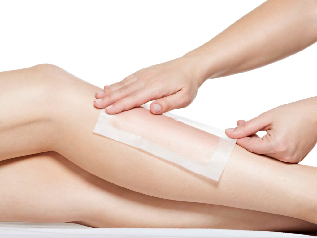 woman depilating legs by waxing