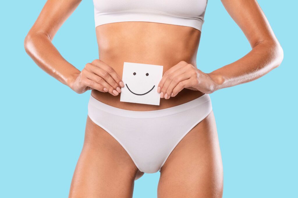 Woman holding paper sticker note with happy smiley face