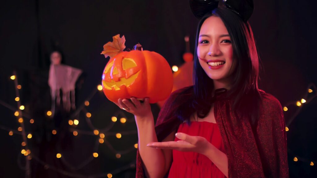 Attractive young woman in witch costumes at Halloween party