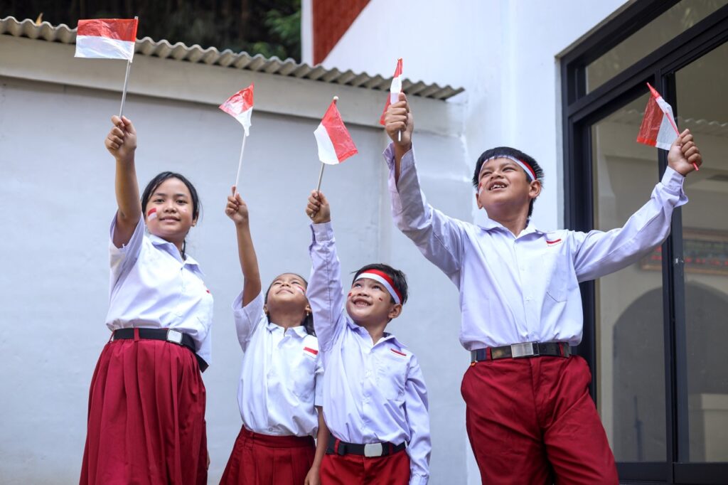 group of cheerful elementary students holding indo 2023 11 27 05 29 18 utc groot