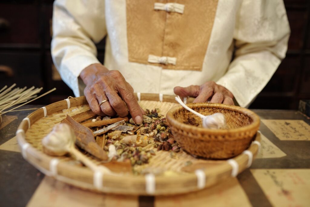 Man Selecting Herbs For Chinese Therapy