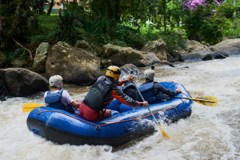 Shot of a group of young male friends white water rafting