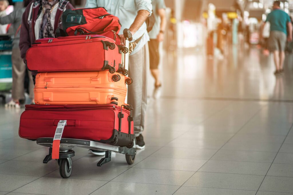 Travelers are walking to drag luggage in modern airport terminal to travel to new places Rear view Copy space Luggage, traveler, travel, airport, walking, holiday concept