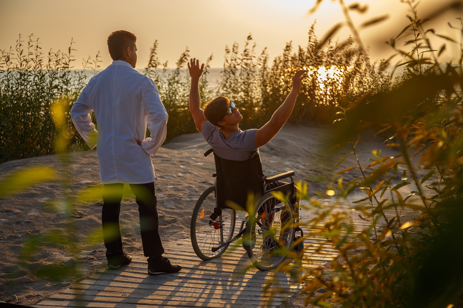 Young man in wheelchair and his doctor