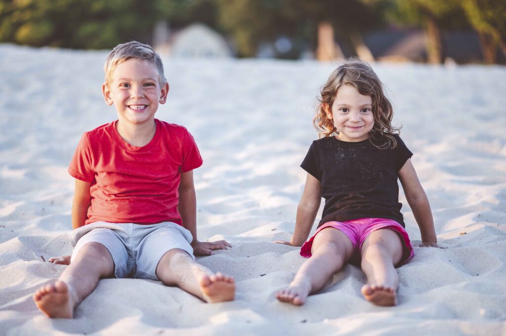 Adorable closeup focus portrait of young siblings at the beach