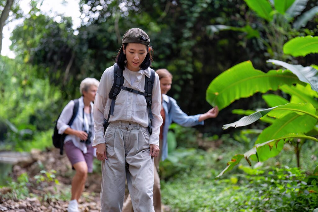 Backpack tourist travel outdoor adventure bird study using binoculars looking and record to book