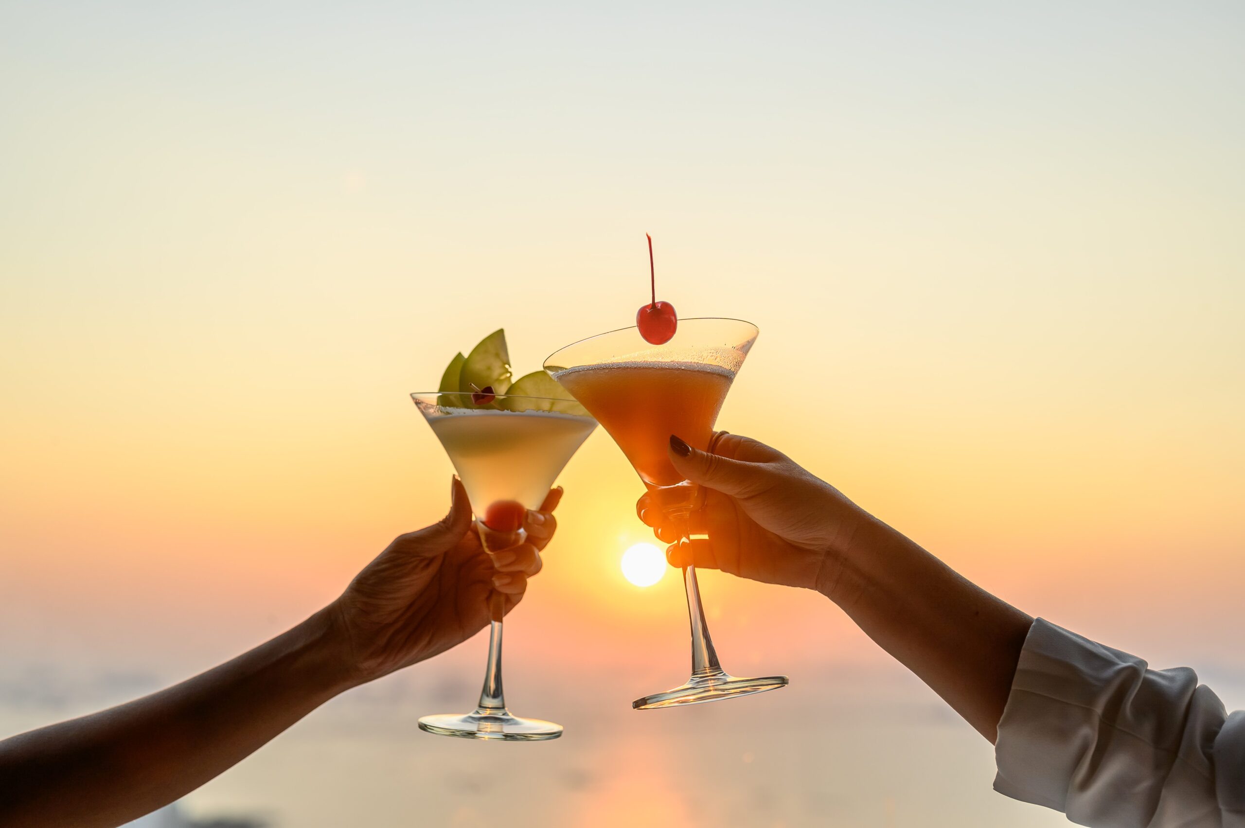 Couple enjoying of Cheers glass of cocktail in a restaurant at sunset view sea Cocktail, Couple, Honeymoon, Dinner, Wine, Romantic concept