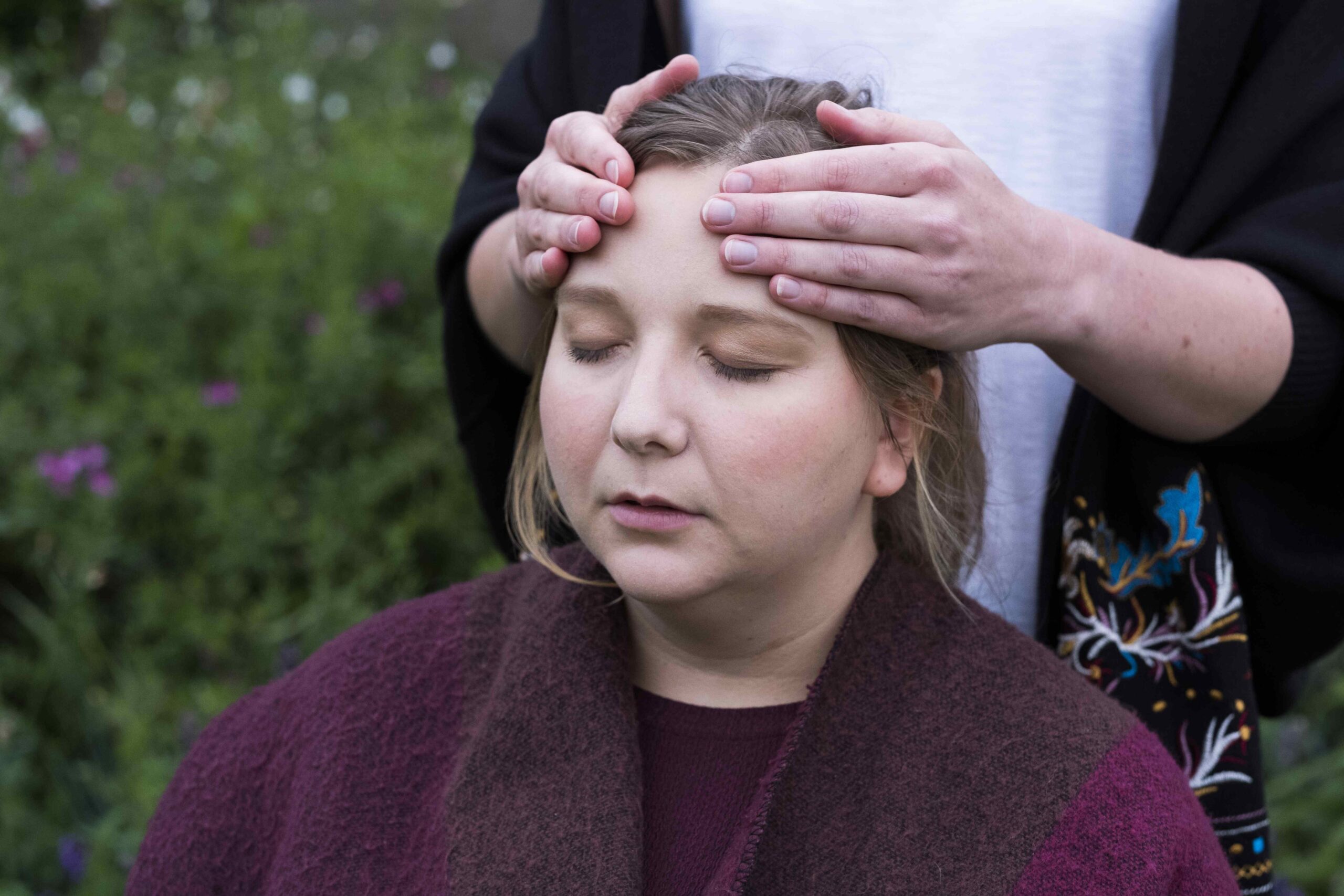 Alternative therapies,United Kingdom,Therapist using both hands touching the top of a client's head