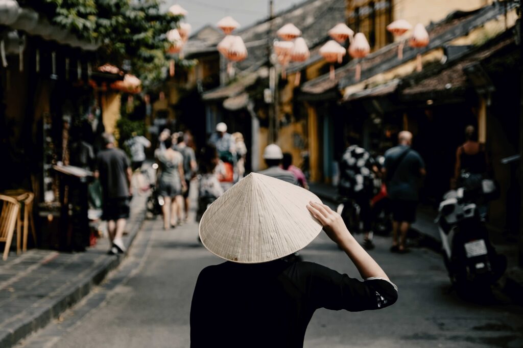 Tourist woman wearing vietnam hat or Non La and sightseeing at Heritage village in Hoi An city in Vietnam