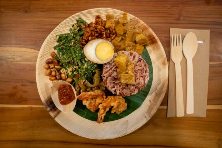 A plate of Balinese food on a bamboo plate