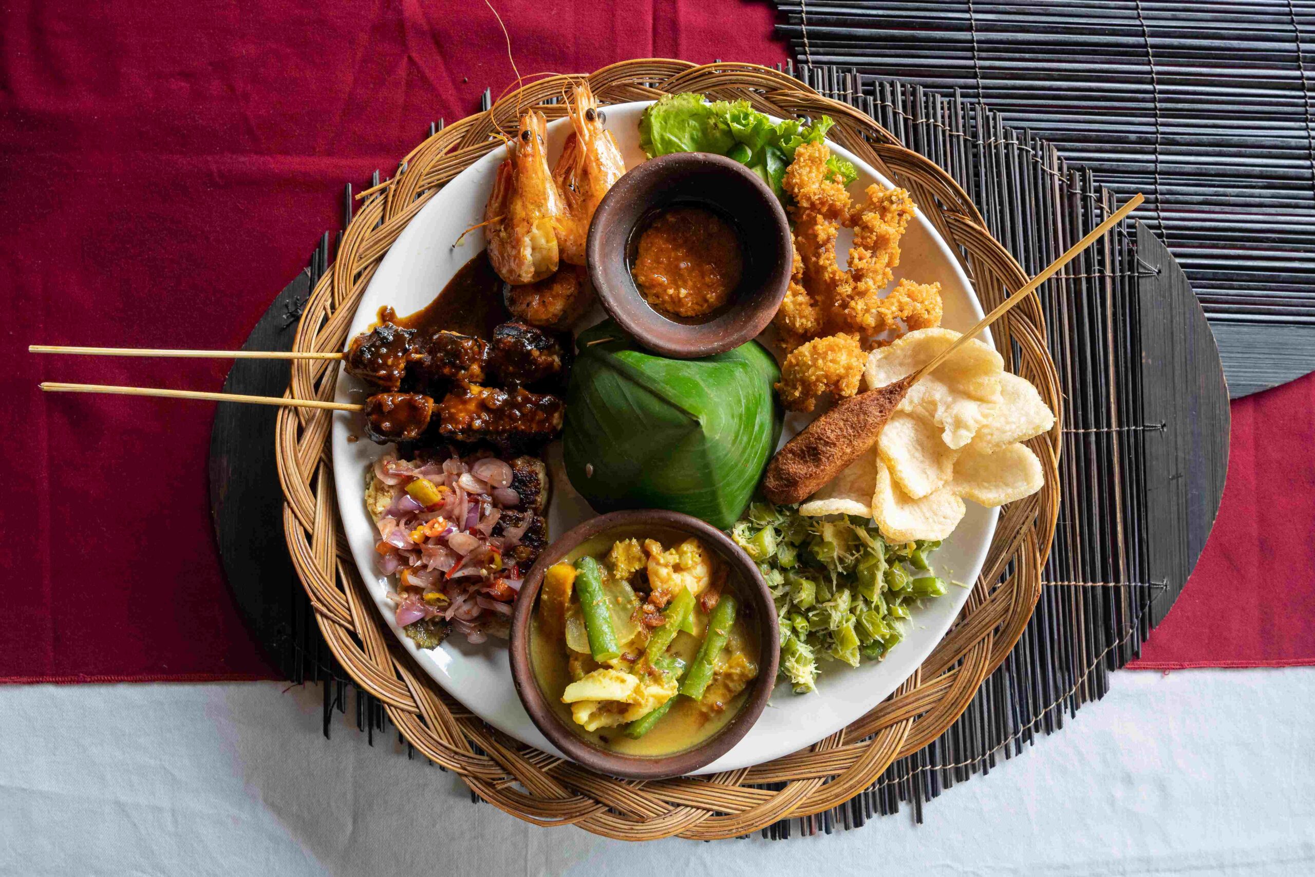 A plate of Indonesian Nasi campur (Indonesian for mixed rice) with seafood