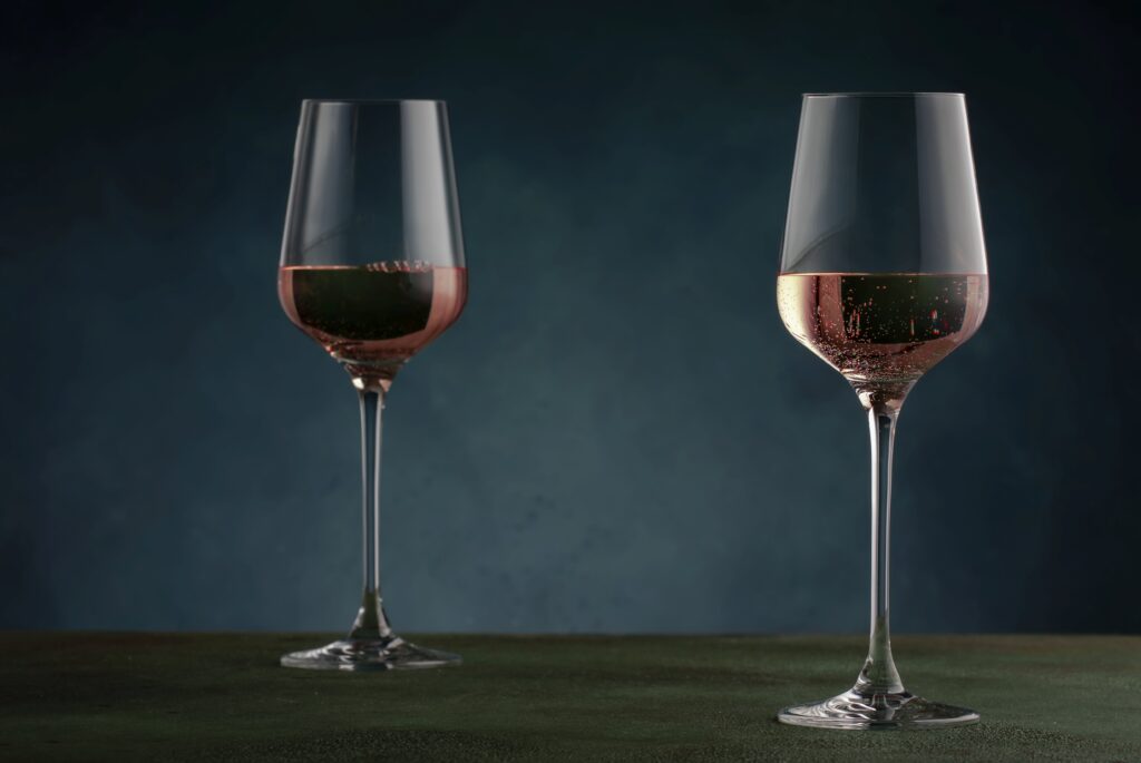 Rose wine from the zinfandel variety in wine glass on dark backg