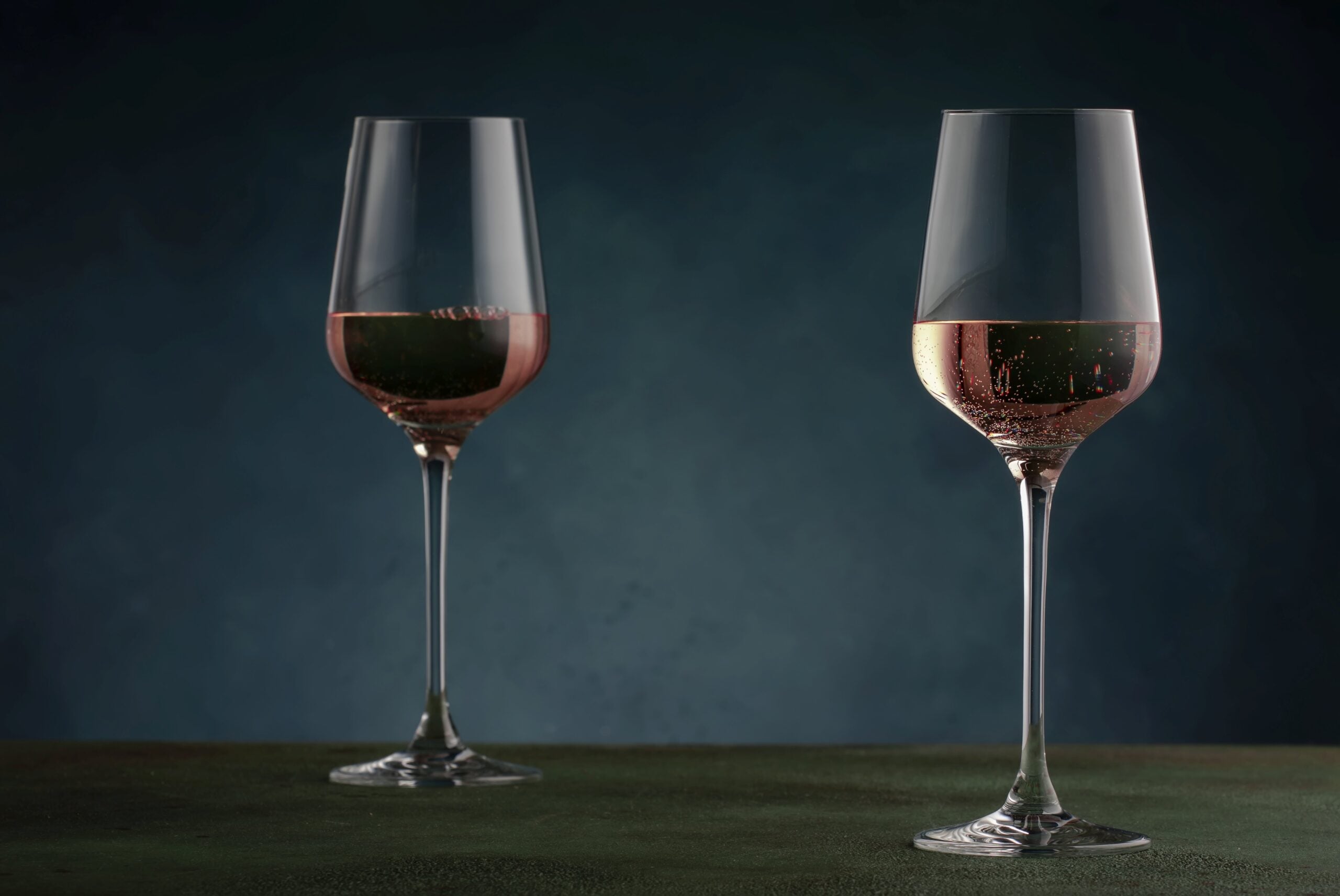Rose wine from the zinfandel variety in wine glass on dark backg