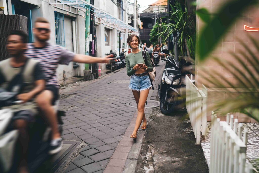 Stylish woman walking on narrow street