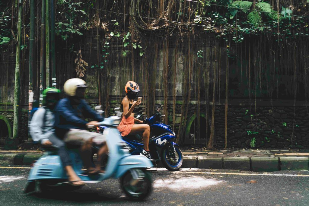 Unrecognizable female biker surfing smartphone