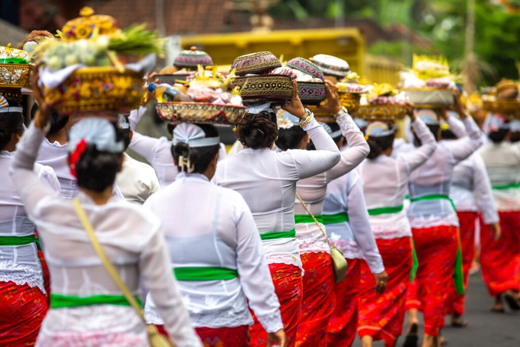 A group of unrecognizable women during a traditional ceremony in front of a temple