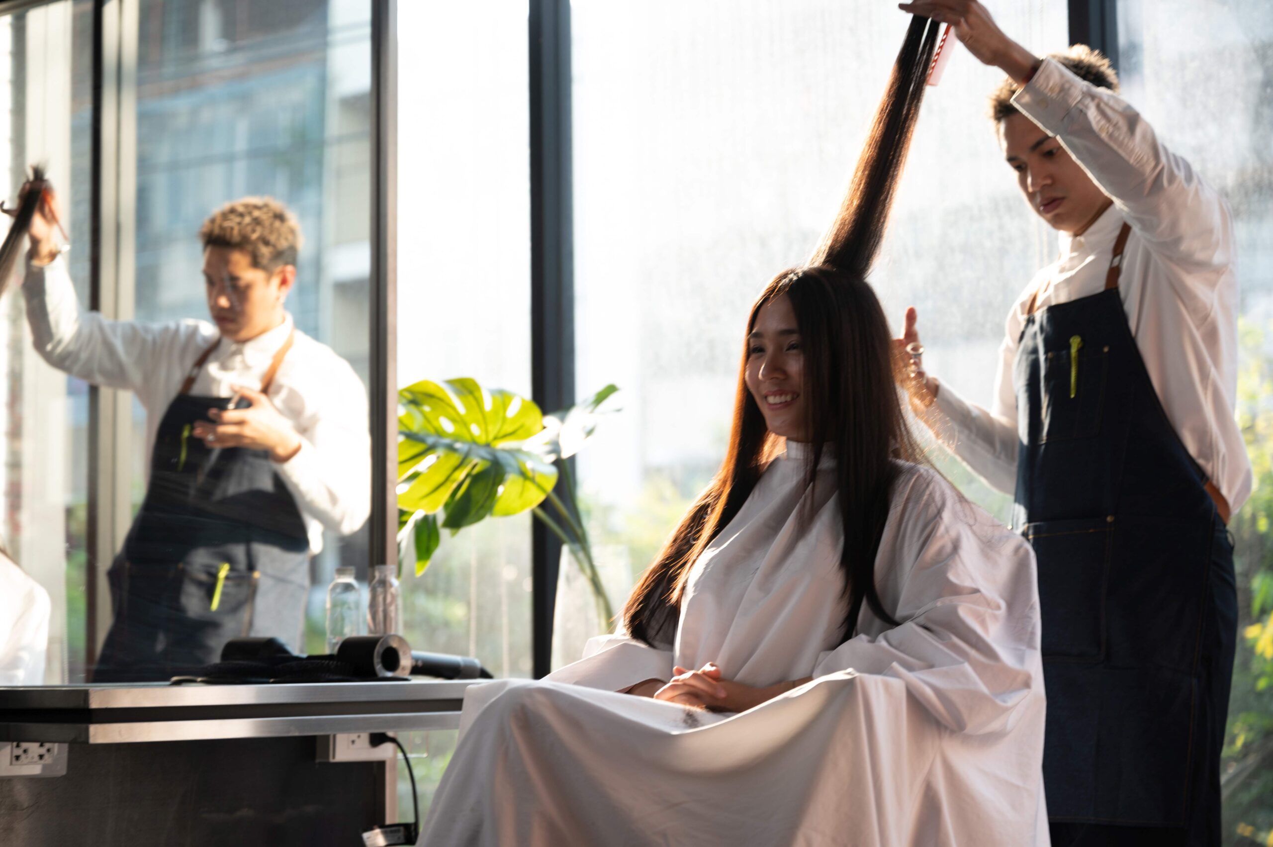 woman client person having a process to making treatment a hair with hairdresser in beauty salon