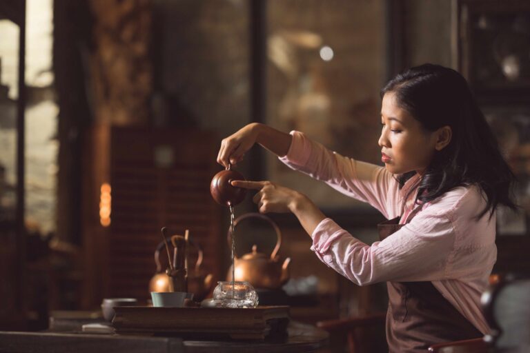 Young girl pouring tea